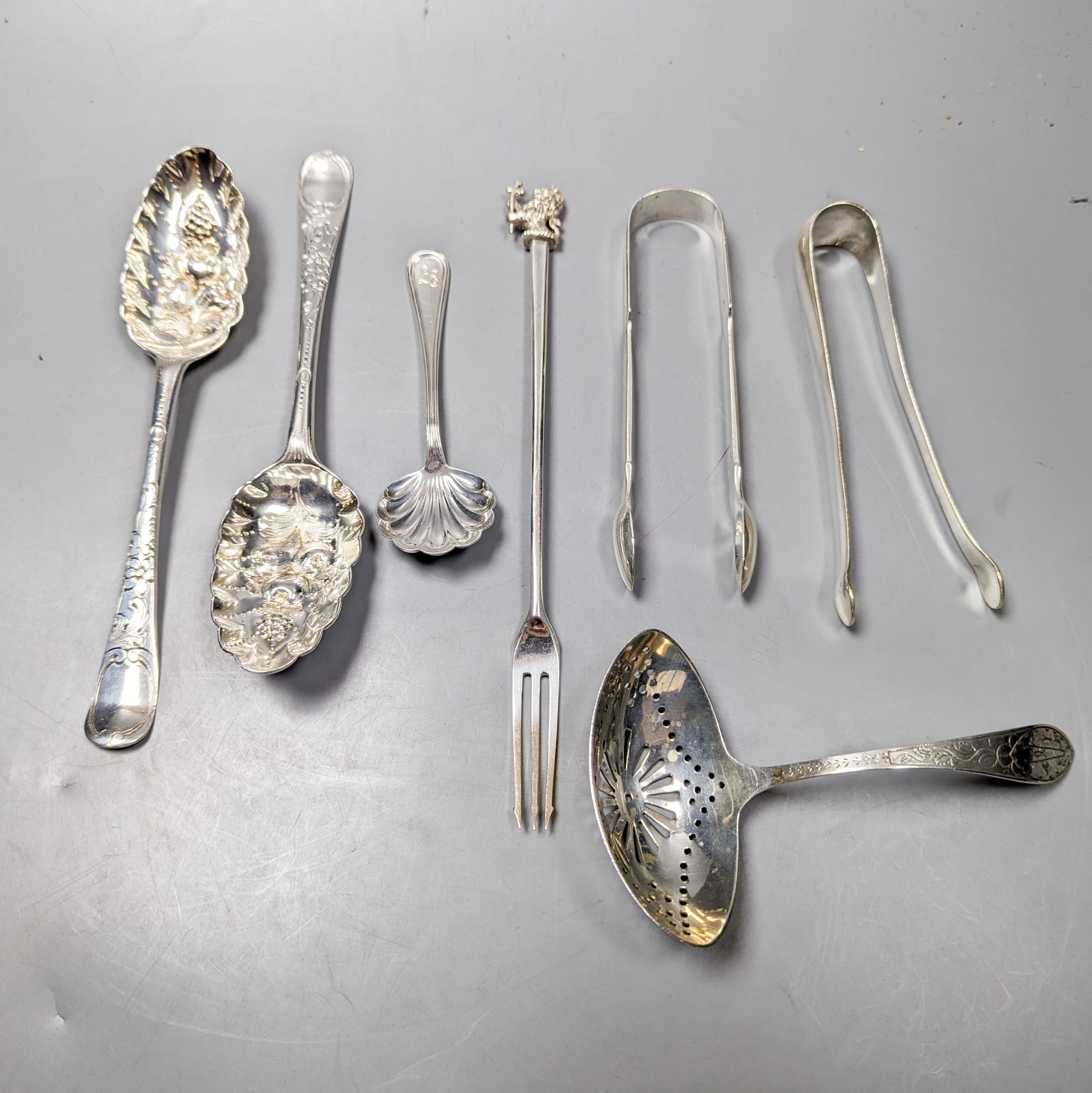 A pair of 18th century silver base mark 'berry spoons', marks pinched and sundry flatware including a Victorian silver pickle fork, a pair of silver sugar tongs, two 800 items of flatware and a pair Christofle plated sug